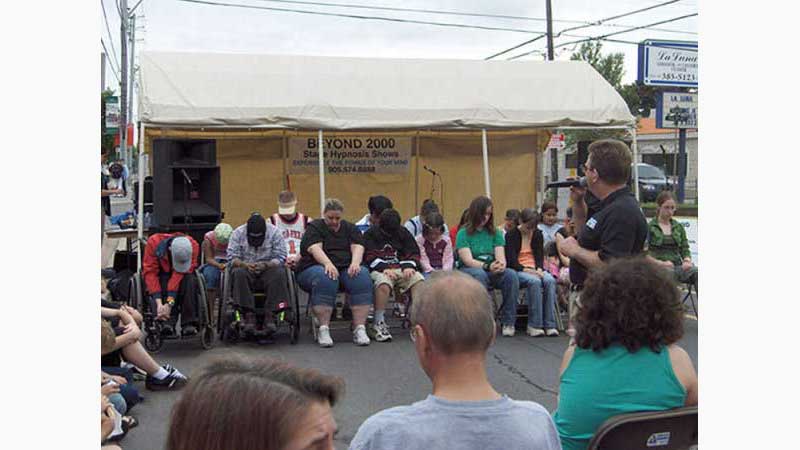 Stage Hypnosis Show 1, Hypnotist Toronto, Volunteers being place in a trance all slumped over in their chairs out like a light. Taken in Toronto Ontario